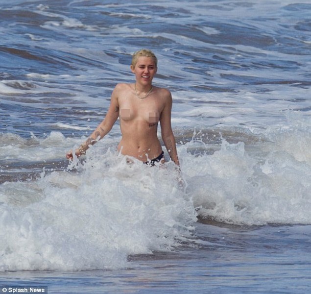 Miley Cyrus topless in the ocean with boyfriend Patrick Schwarzenegger 